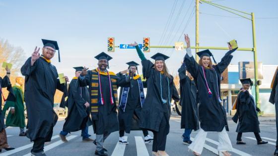ODU Commencement, students walking across Hampton Blvd. on their way to commencement exercises