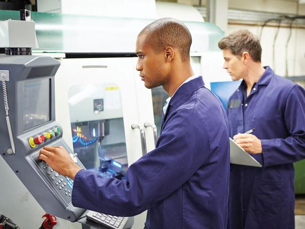 Industrial engineers monitor a manufacturing system