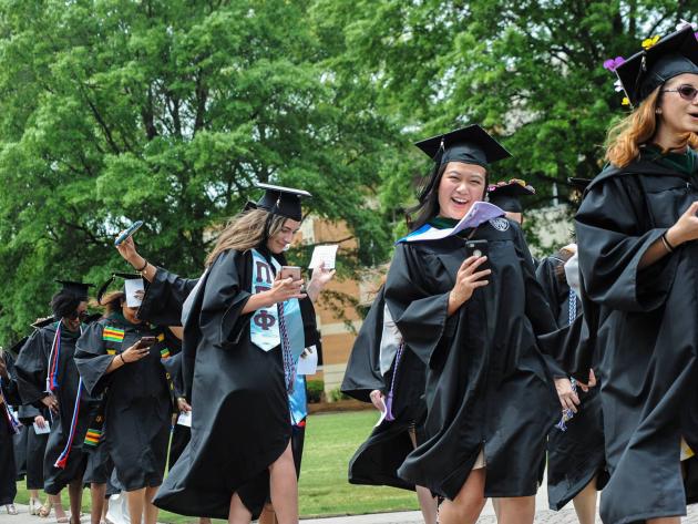ODU graduates walk across the seal on commencement day