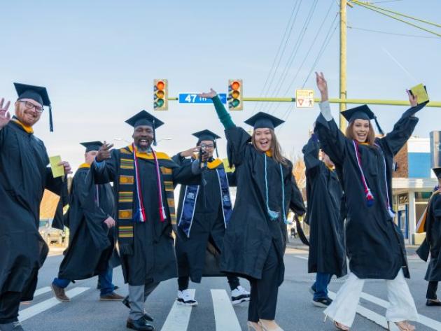 ODU Commencement, students walking across Hampton Blvd. on their way to commencement exercises